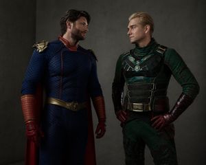 Generates a cinematic studio portrait of two actors wearing swapped supe...